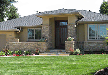 Front view of a one-story home with stonework and detailed architectural features
