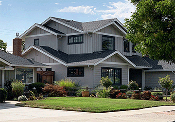 Angled view of a two-story home with complex, complementary rooflines