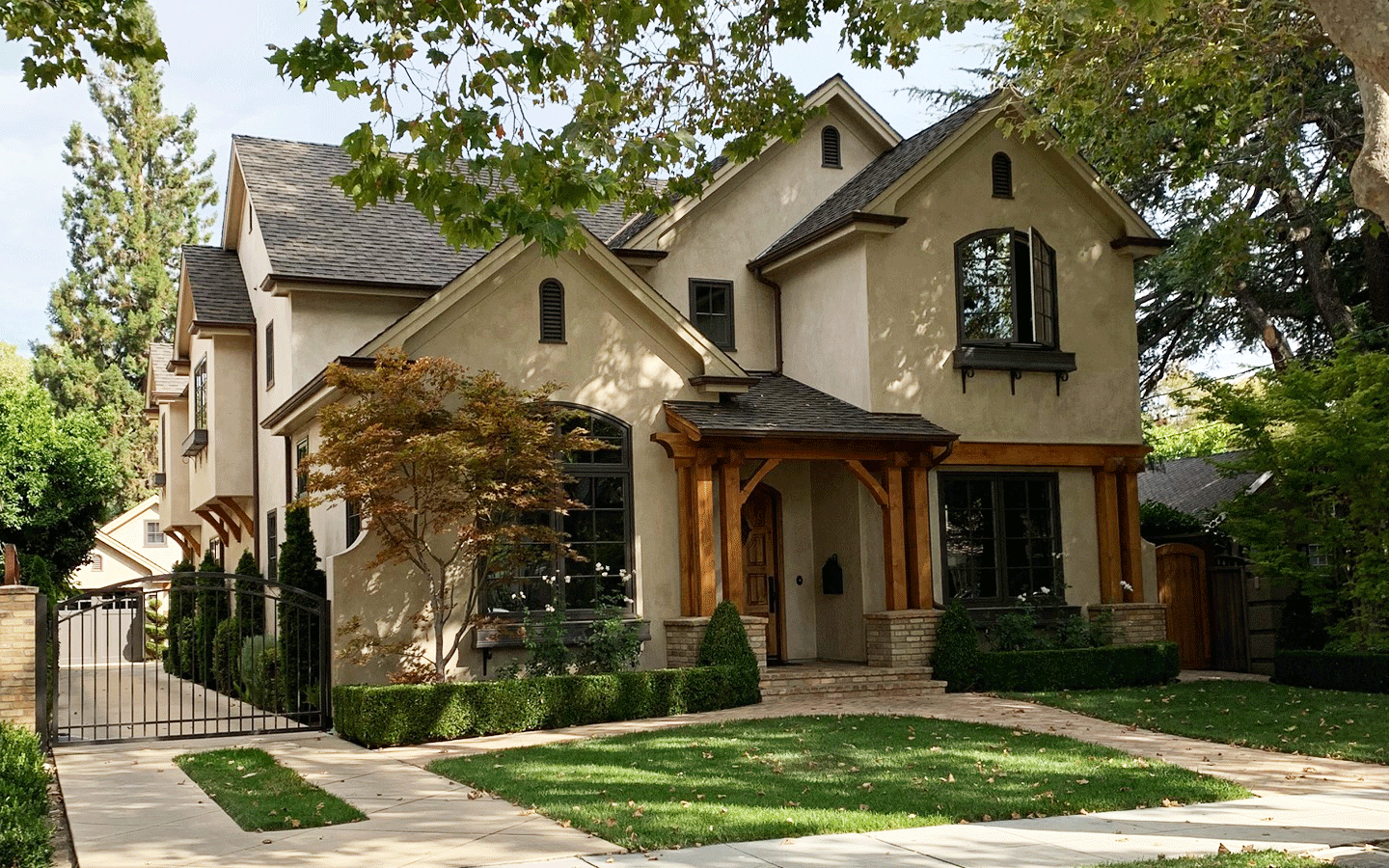 Front view of a two-story home with multiple gables and detailed porch features